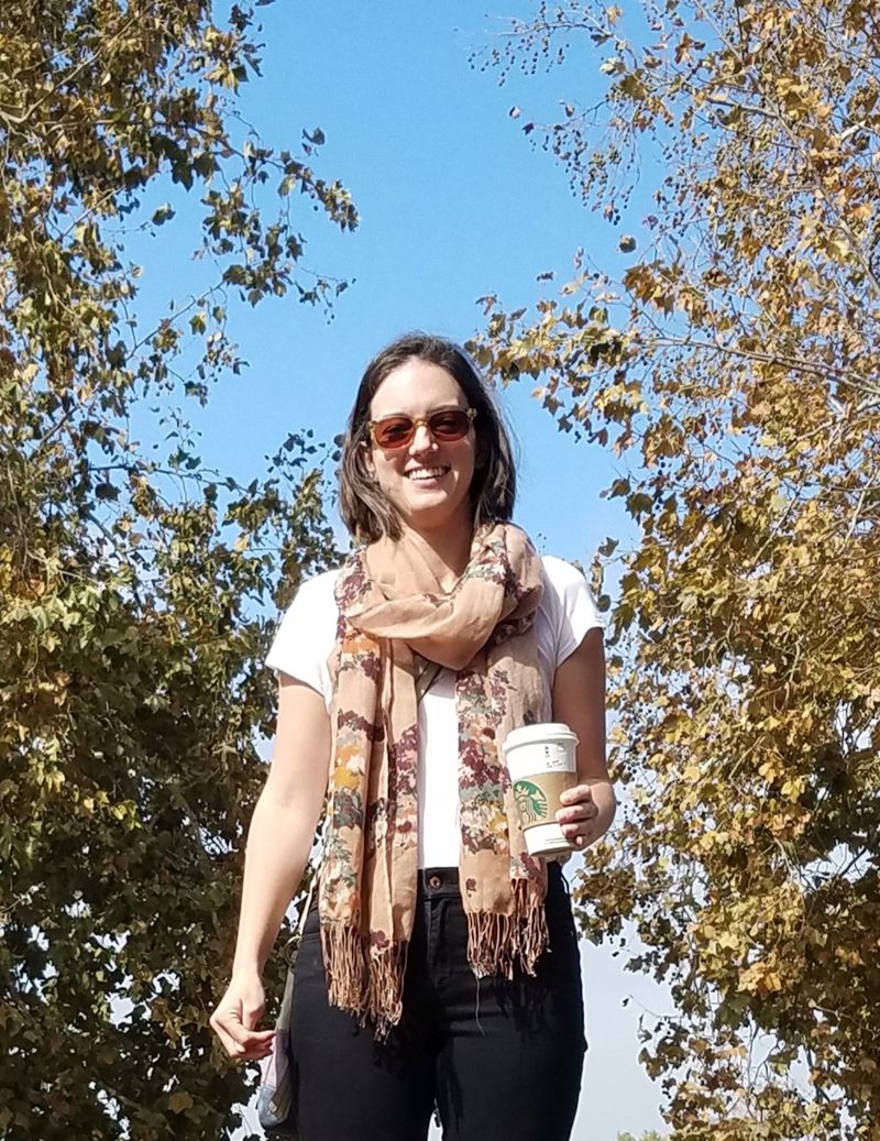 Ashley Broderick, LCSW, smiling outdoors on a sunny fall day